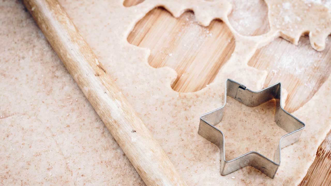 [photograph of a cookie cutter on dough]