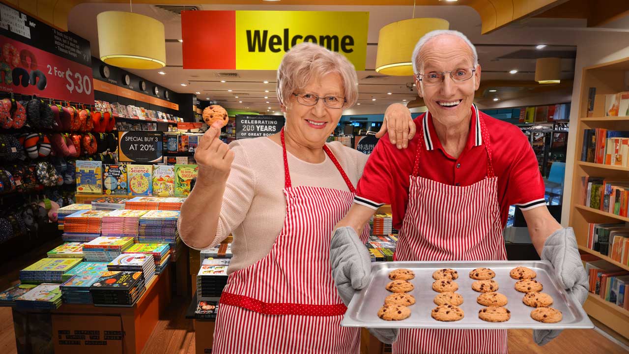 [photograph of an eldery couple offering cookies at a store entrance]