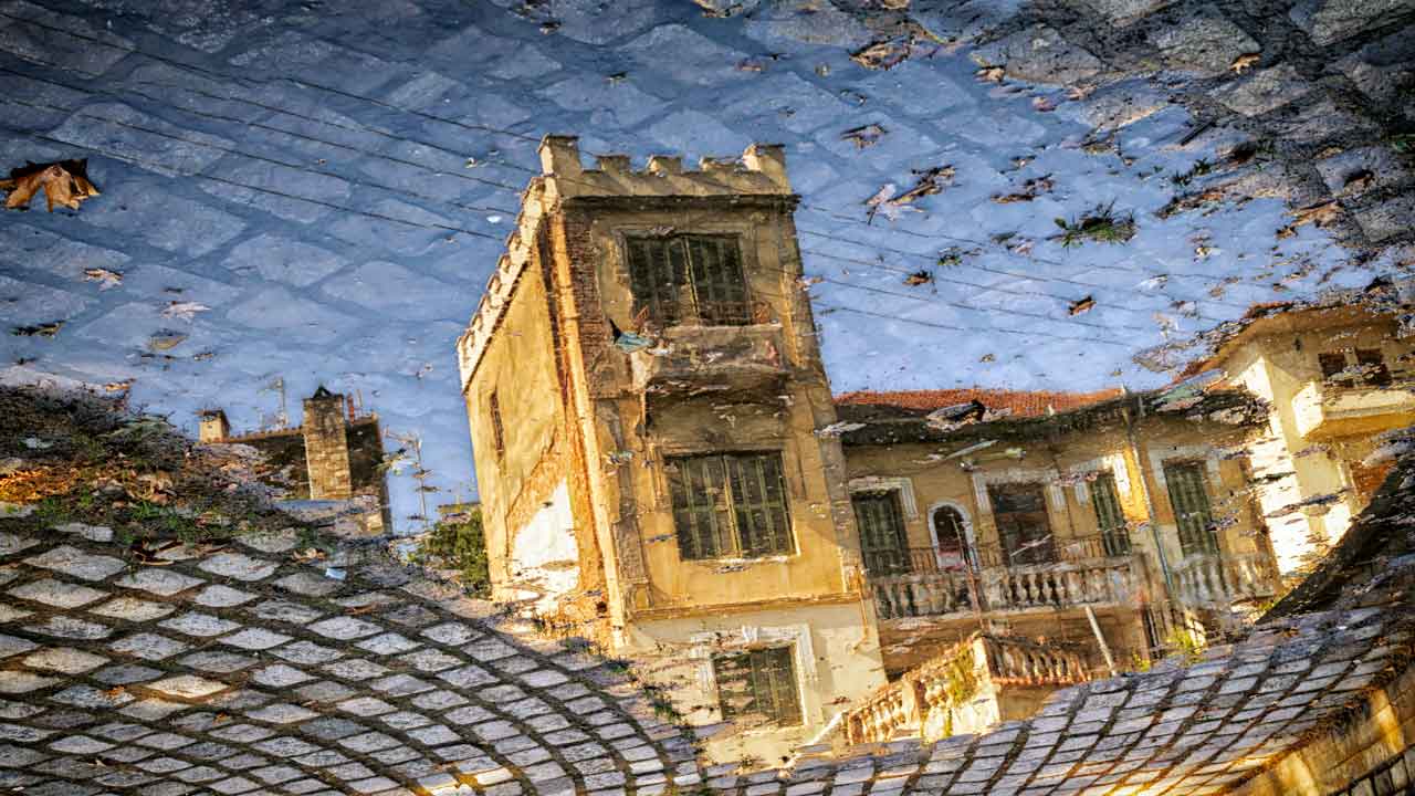 [photograph of a building reflected in a puddle]